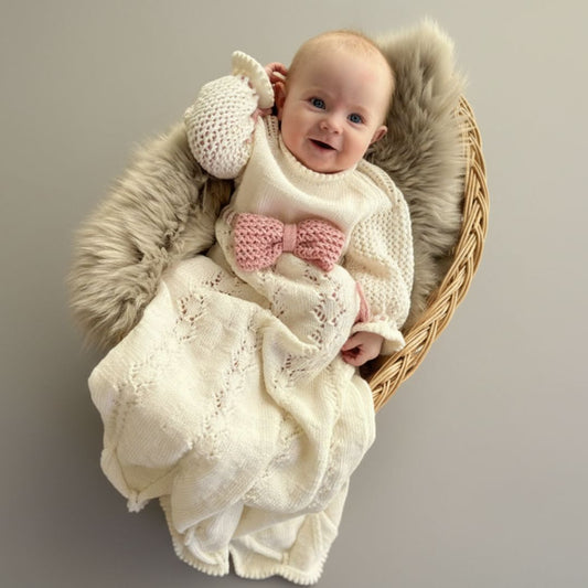 Strikket dåpskjole på baby – strikkepakke dåpskjole med silkebånd eller strikket bånd du kan strikke selv. Strikke dåpskjole til baby med knytting i nakken for enkel av- og påkledning. Unik strikkepakke dåpskjole med valgfritt bånd.