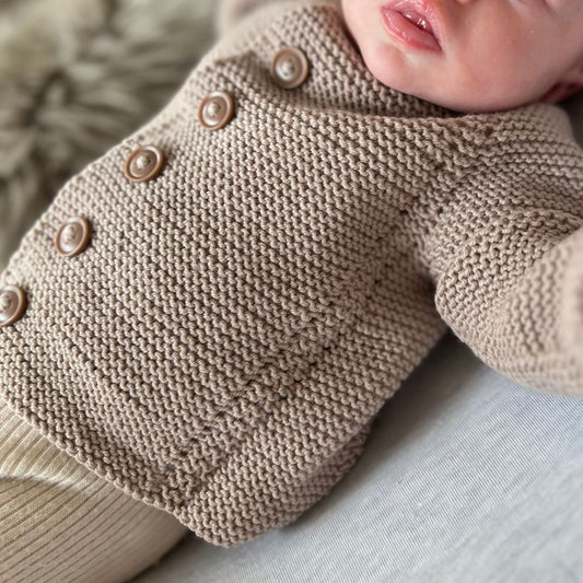 Nydelige detaljer i strikkejakke til baby. Strikkeoppskrift til baby og barn. Hullmønster. Rillestrikk.